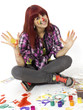 Portrait of young joyful girl drawing with motley paints