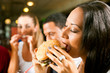 Friends eating fast food in a restaurant