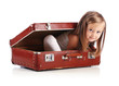 Photo: Happy small girl sitting in a suitcase. Travel concept. Isolated Happy small girl sitting in a suitcase. Travel concept. Isolated