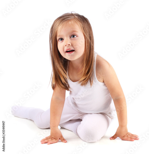 One beautiful small girl sits on white background Isolated
