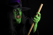 Witch flying on her broomstick. Black background.
