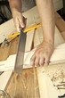 Man sawing plank