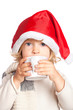 Child in Santa hat drinking hot chocolate Child in Santa hat drinking hot chocolate