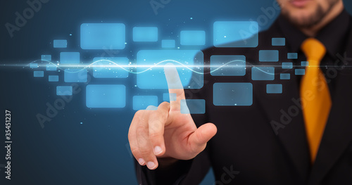 Photo: Businessman pressing high tech type of modern buttons Businessman pressing high tech type of modern buttons