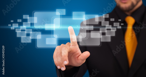 Photo: Businessman pressing high tech type of modern buttons Businessman pressing high tech type of modern buttons