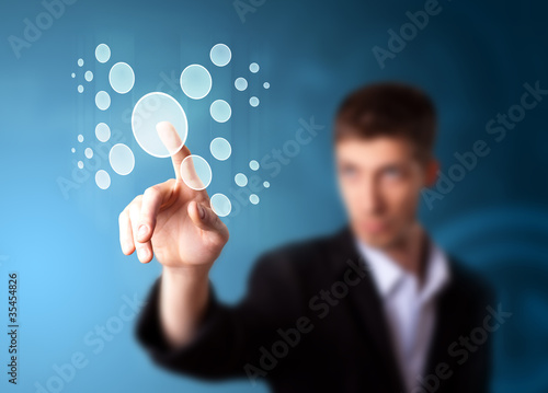 Photo: Businessman pressing high tech type of modern buttons Businessman pressing high tech type of modern buttons