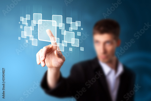 Foto: Businessman pressing high tech type of modern buttons Businessman pressing high tech type of modern buttons
