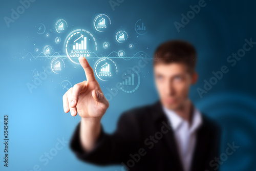 Photo: Businessman pressing modern business type of buttons Businessman pressing modern business type of buttons