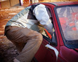 Hooligan smashing windshield