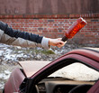 Hooligan smashing windshield