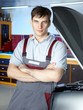 Master mechanic is proud of his job in a garage