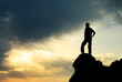Man on peak of mountain.