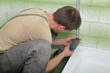Plumber using screwdriver or drill Plumber using screwdriver or drill