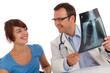 Doctor and patient looking an x-ray image Doctor and patient looking an x-ray image
