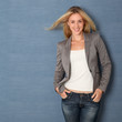 Beautiful blond woman standing on grey background Beautiful blond woman standing on grey background