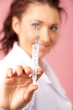 Female doctor hand holding syringe
