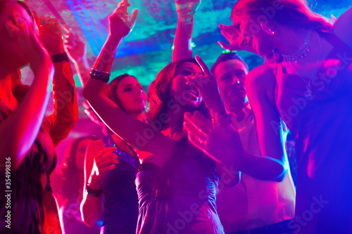 Photo: Party people dancing in disco or club Party people dancing in disco or club