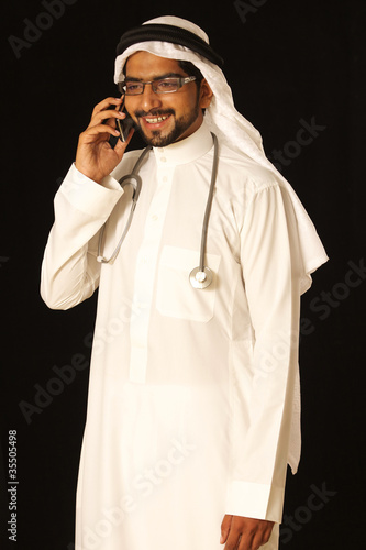 Photo: Arab doctor on phone Arab doctor on phone