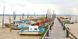 Rugged Fishing Boats and Pier at Low tide in Malaysia