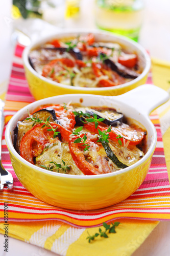 Photo: Vegetable casserole with cheese on white background Vegetable casserole with cheese on white background