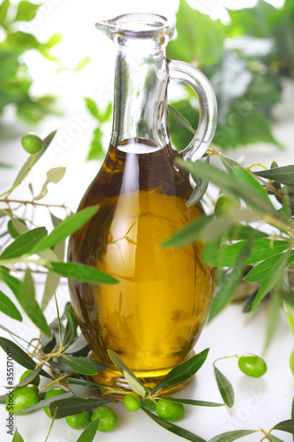 Photo: bottle of olive oil with branch olives bottle of olive oil with branch olives