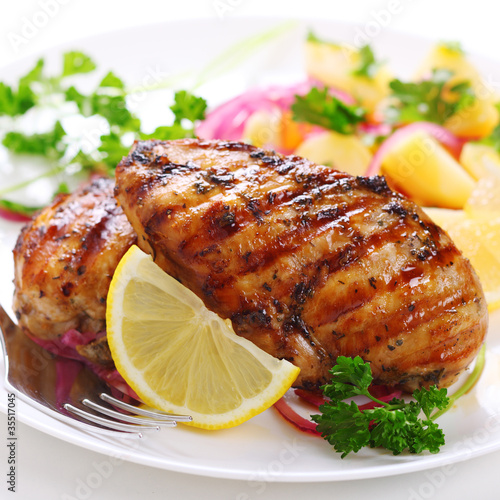 Photo: Grilled chicken breast on white plate Grilled chicken breast on white plate