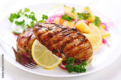 Photo: Grilled chicken breast on white plate Grilled chicken breast on white plate