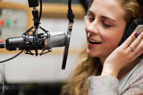 Photo: Close up of a singer recording a track Close up of a singer recording a track