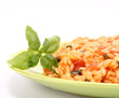 Risotto with tomatoes decorated with basil Risotto with tomatoes decorated with basil