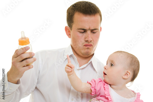 Photo: A young father with a baby on a white background. A young father with a baby on a white background.