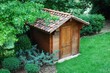 Wooden garden tool shed in a beautiful park Wooden garden tool shed in a beautiful park