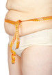 Fat woman measuring her stomach