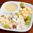 Cheese plate with grapes and honey