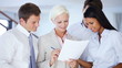 Business people examining documents together at office