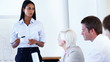 Business woman giving presentation to business group