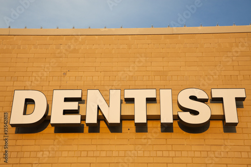 Photo: Dentist sign on the brick wall Dentist sign on the brick wall