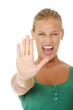bright picture of young woman making stop gesture.