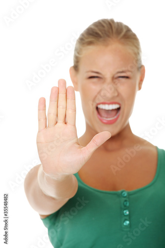Photo: bright picture of young woman making stop gesture. bright picture of young woman making stop gesture.