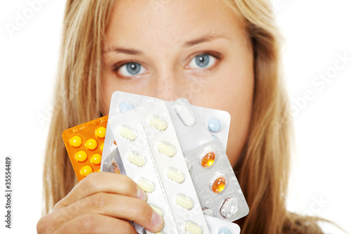 Photo: Young beautiful woman with pills. Young beautiful woman with pills.