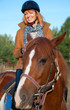 A woman riding a horse