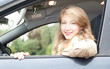 young beautiful woman driving her new car