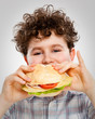Boy eating big sandwich