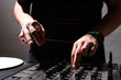 Hands of a DJ playing music from vinyl