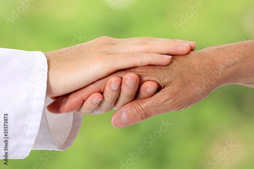 Photo: Woman hand helping senior in nature Woman hand helping senior in nature