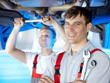 Motor mechanic is satisfied with his job in a garage