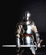 Heavy armoured man holding his sword
