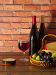 Red wine, fruit and cheese in a basket