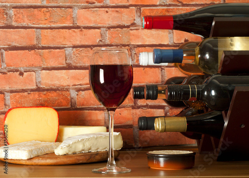Photo: Wine rack , glass of wine and cheese Wine rack , glass of wine and cheese