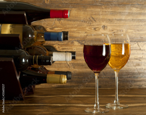 Photo: Wine rack and two glasses of wine Wine rack and two glasses of wine