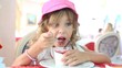 A little girl eat yogurt with jam